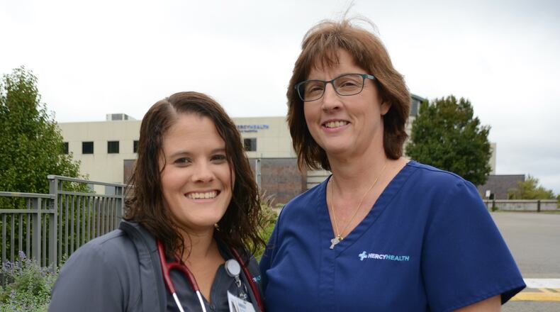 Amber Preston, a respiration therapist at Mercy Hospital-Fairfield, (left) and Kathy Harvey, a registered nurse at Mercy Hospital-Fairfield, saved the life of Steve Moore, a Fairfield resident who collapsed outside the Mercy HealthPlex on the Fairfield hospital’s Mack Road campus. MICHAEL D. PITMAN/STAFF