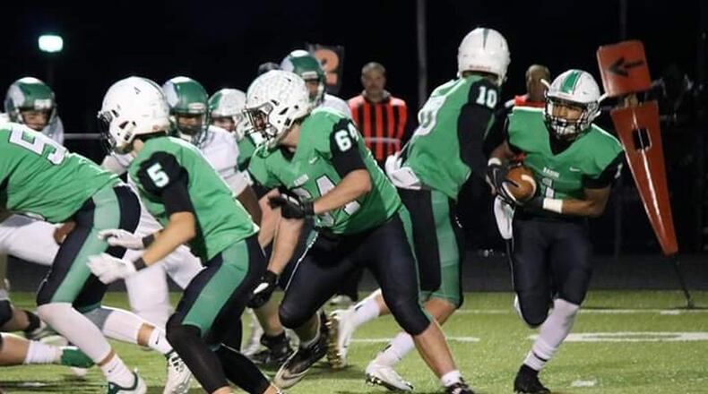 Badin’s Davon Starks (1) takes a handoff from quarterback Zach Switzer (10) during last Friday’s 48-6 win over McNicholas at Virgil Schwarm Stadium in Hamilton. CONTRIBUTED PHOTO BY TERRI ADAMS