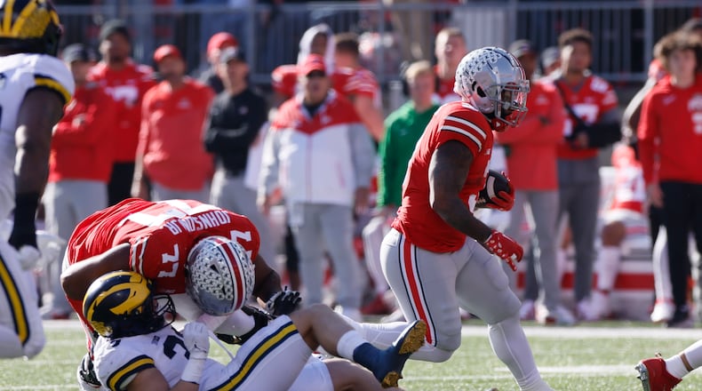 Ohio State running back Miyan Williams, right, follows a block by teammate Paris Johnson against Michigan during the first half of an NCAA college football game on Saturday, Nov. 26, 2022, in Columbus, Ohio. (AP Photo/Jay LaPrete)