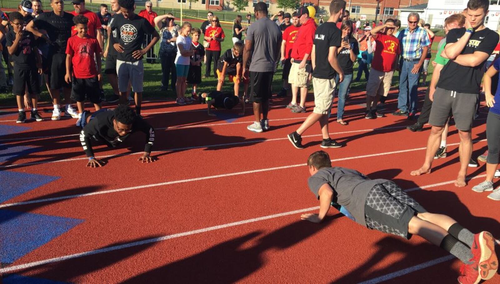 These are some of the people who participated in a push-up challenge at the 'Pray Collin Strong' event at Tecumseh High School on Monday night, May 22, 2017. (James Buechele/Staff)