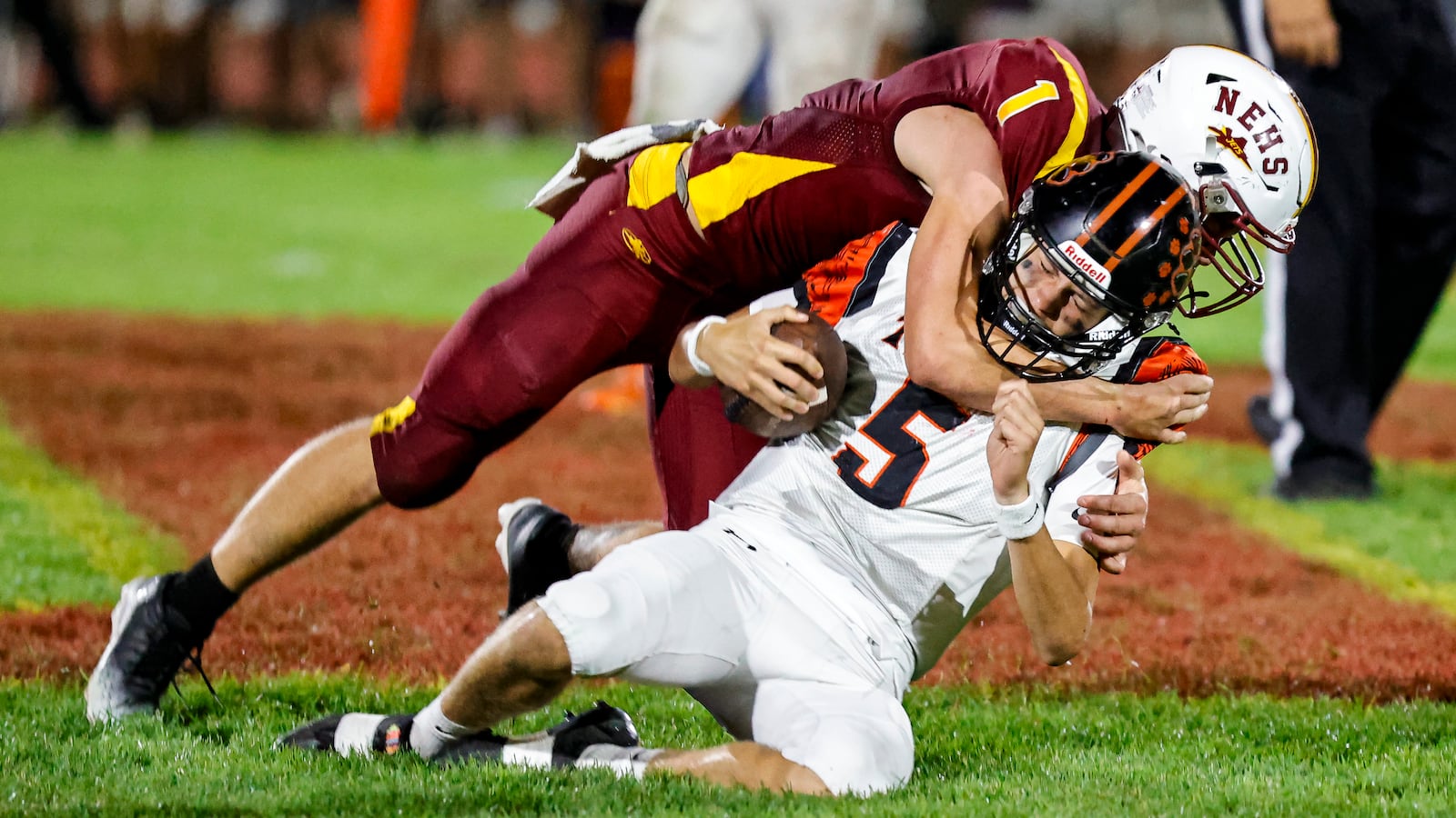 Northeastern High School senior linebacker Cody Houseman tackles West Liberty-Salem sophomore quarterback Beckett Sullivan during their game on Friday, Oct. 3 at Conover Stadium in Springfield. The Jets won 27-24. MICHAEL COOPER / STAFF