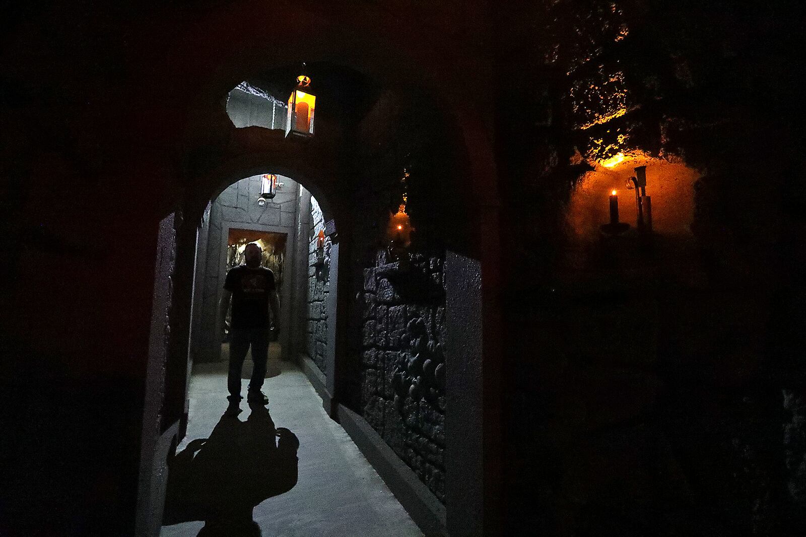 A worker stands in a doorway of the new wine cellar added to the Face Your Fears Hotel of Terror this year. BILL LACKEY/STAFF