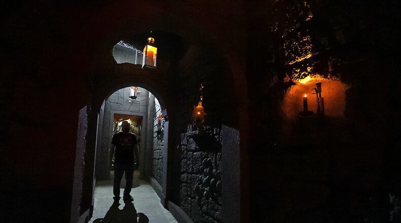 A worker stands in a doorway of the new wine cellar added to the Face Your Fears Hotel of Terror this year. BILL LACKEY/STAFF