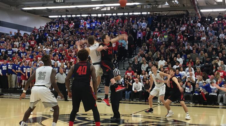 Lakota West’s Mitch Wagner winning the opening tipoff against Lakota East’s Alex Mangold in front of a packed crowd at the Hawks Nest. East won 58-48. Laurel Pfahler/CONTRIBUTED