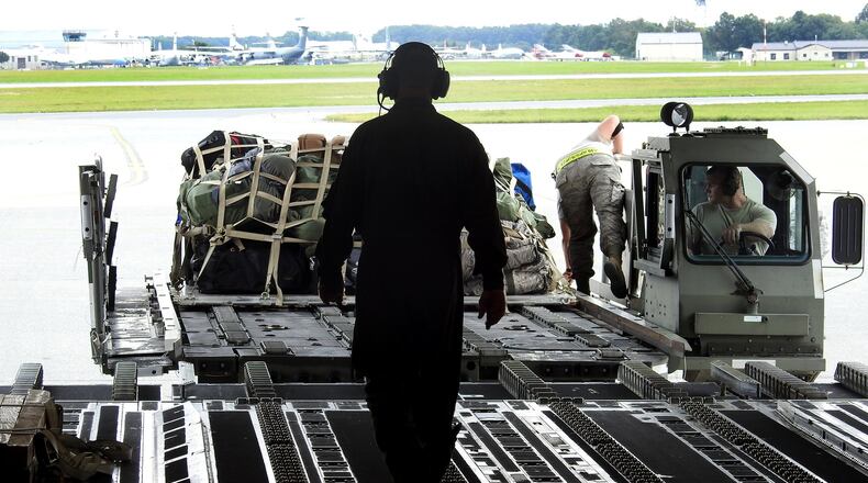 A Wright-Patterson based Air Force Reserve crew loads luggage at Joint Base McGuire-Dix-Lakehurst in New Jersey after picking up troops and supplies to deliver to Florida to assist with Hurricane Irma recovery efforts in September 2017. BOB GARLOCK / STAFF