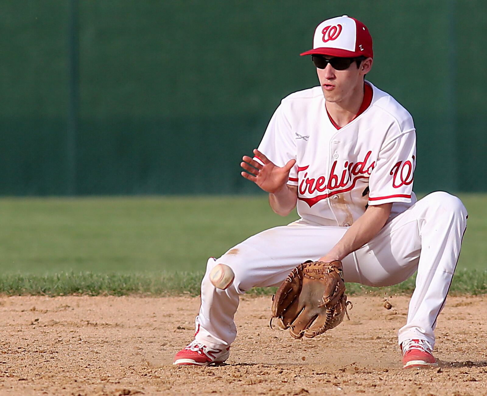 Lakota West second baseman Frankie Schmitt fields a Hamilton ground ball during Sunday’s game in West Chester Township. CONTRIBUTED PHOTO BY E.L. HUBBARD