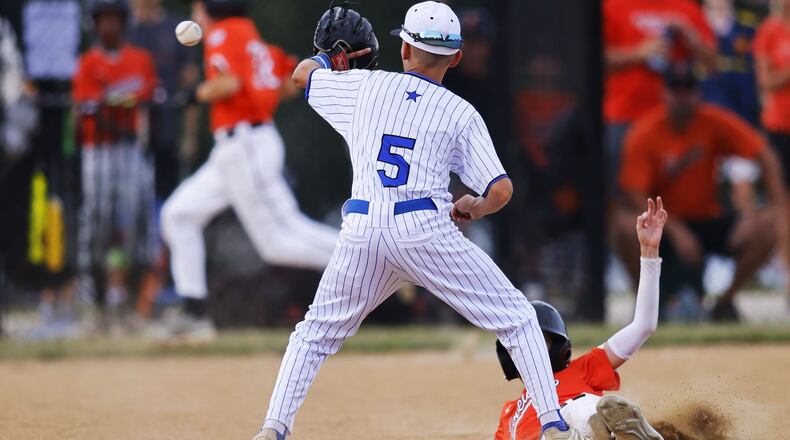 Hamilton's Blake Sams catches a ball at second base as a runner slides in during Hamilton West Side Little League's 10-1 win over Loveland in the District 9 Little League championship Monday, July 11, 2022 at Home of the Brave Park in Loveland. NICK GRAHAM/STAFF