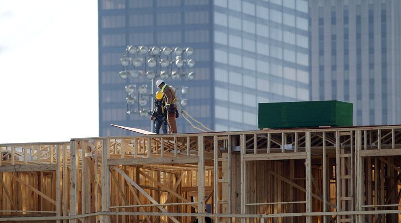 Workers build out the Centerfield Flats on East First Street next to what was then Fifth Third Field (now Day Air Ball Park) downtown in this 2019 photo. FILE