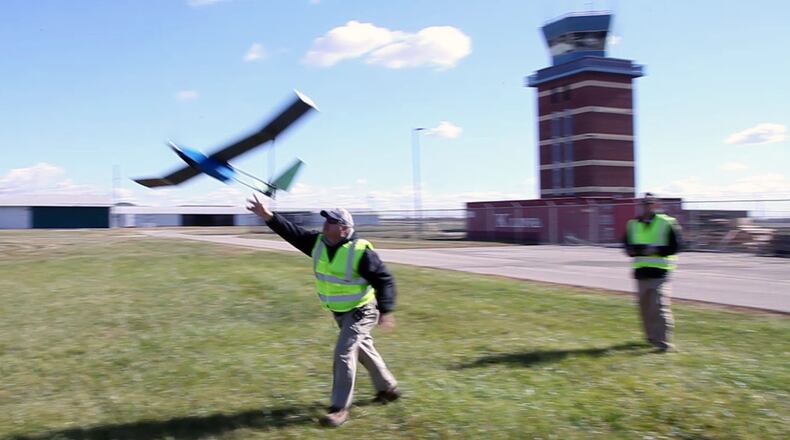SelectTech Geospatial’s Executive Director Frank Beafore, left, launches a UAS as chief pilot Jade Lowrey flies at the company’s Springfield location in October 2015. TY GREENLEES / STAFF