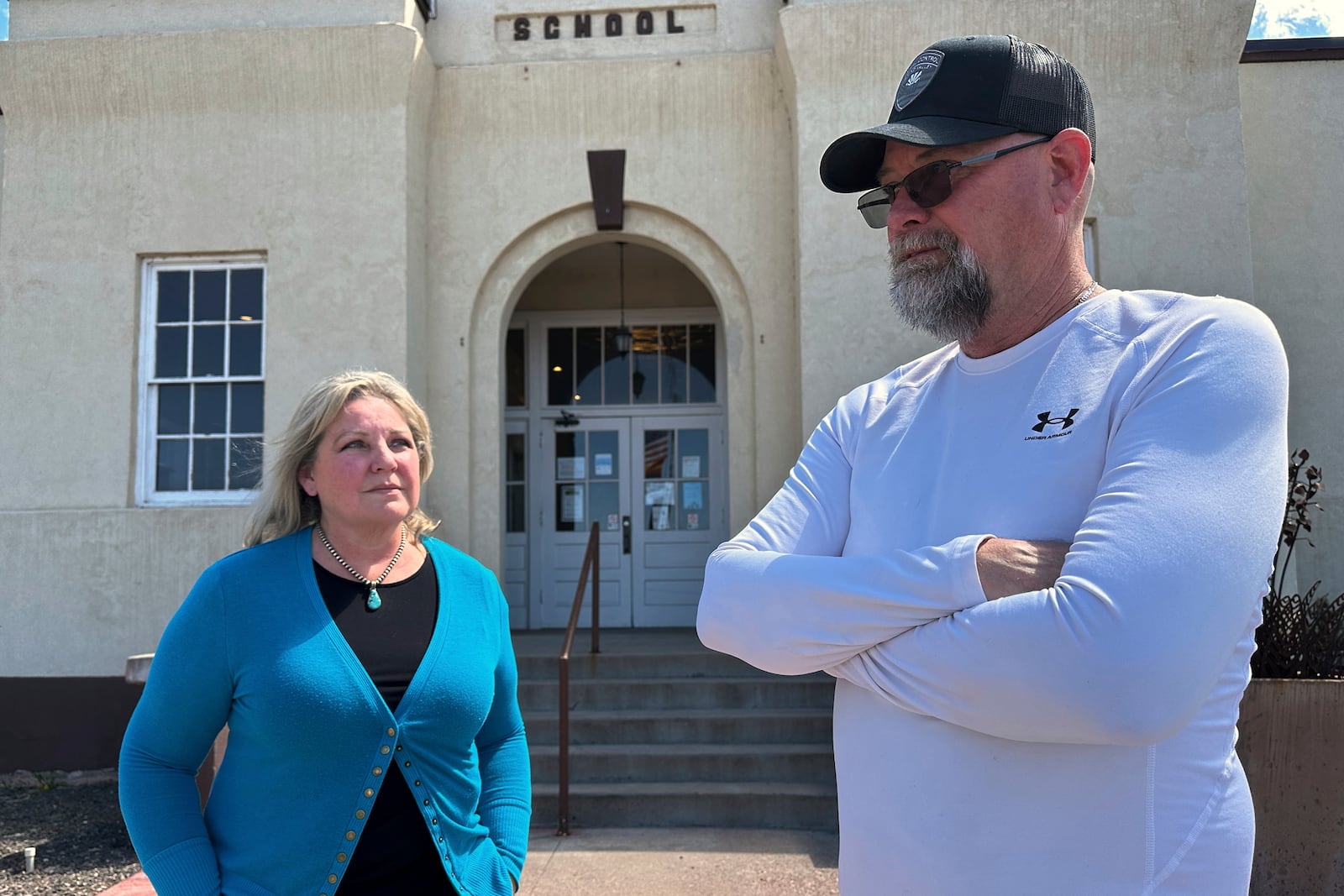 Town Manager Tim Rasmussen, right, and Mayor Shelly Reidhead discussing the economic importance of the coal-fired Springerville Generating Station, while standing outside town hall in Springerville, Ariz., Tuesday, April 22, 2025. (AP Photo/Susan Montoya Bryan)