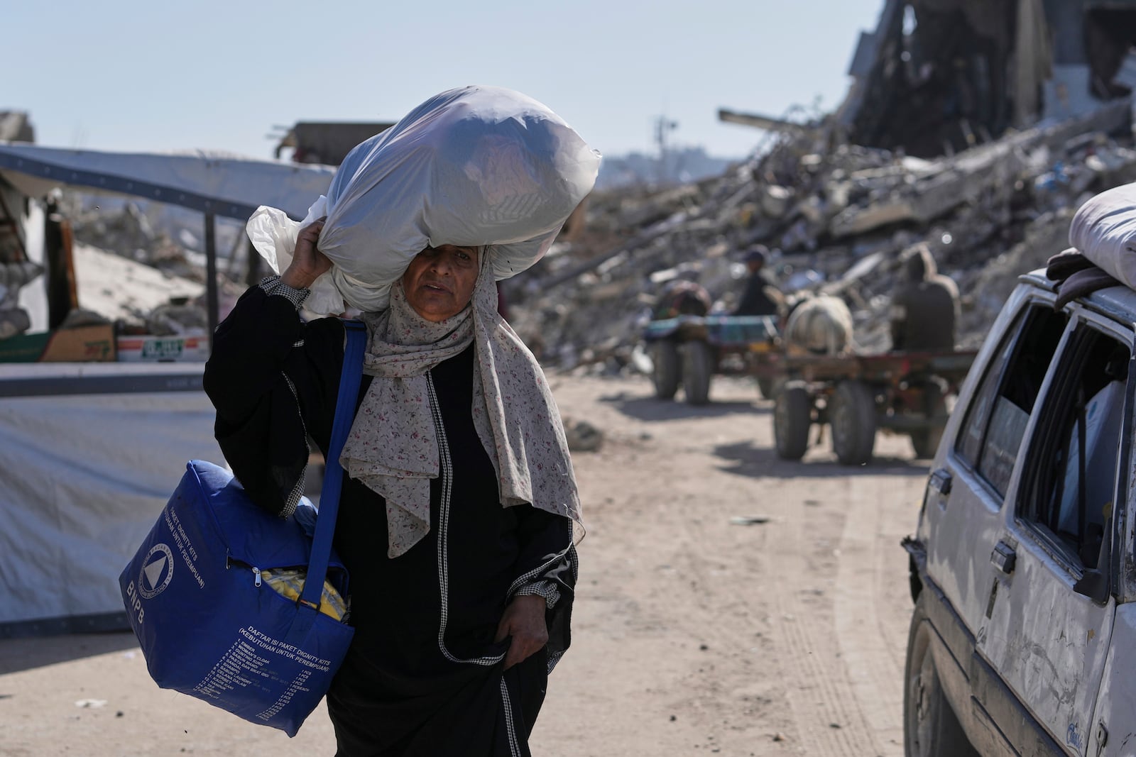 Displaced Palestinians fleeing Beit Lahia amid ongoing Israeli military operations in the Gaza Strip arrive in Jabalia, northern Gaza, on Friday, May 16, 2025. (AP Photo/Jehad Alshrafi)