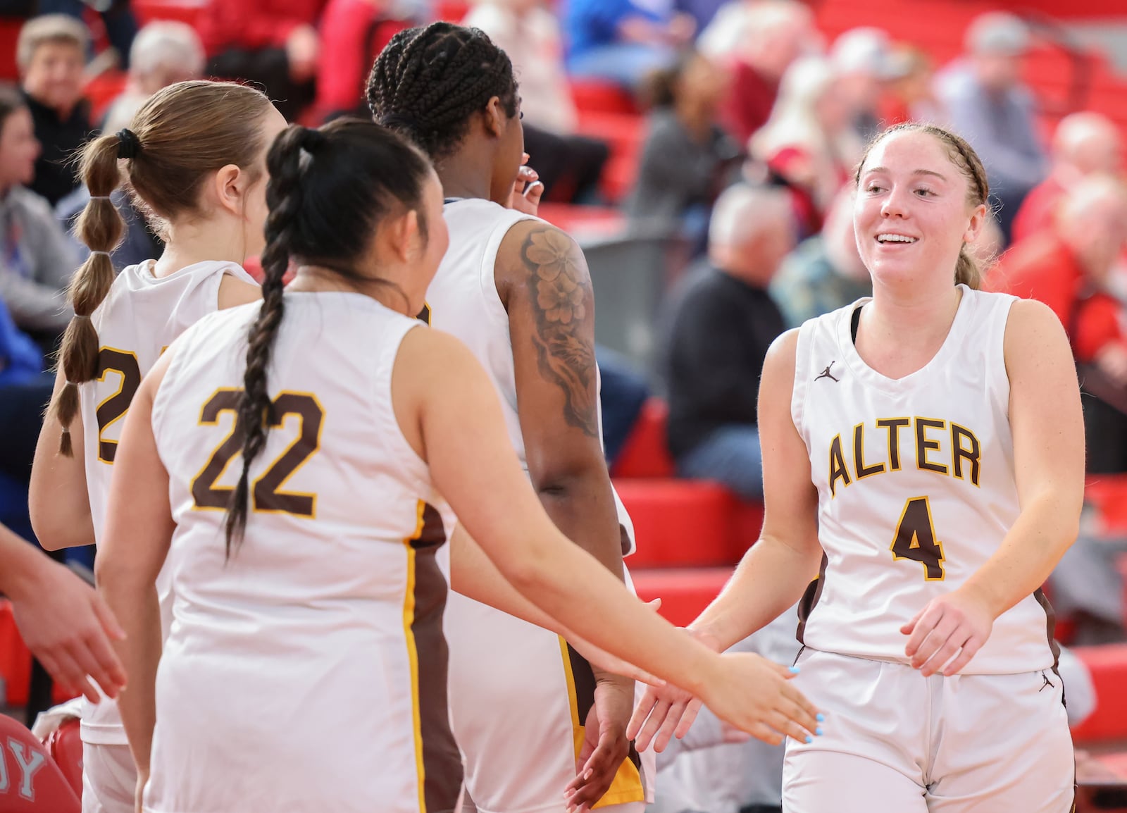 Alter senior guard Alison Link claps hands with teammates after returning to the bench late in a 40-29 win over Cincinnati Indian Hill on Saturday, Feb. 28 at Troy High School's Trojan Activities Center. BRYANT BILLING / STAFF