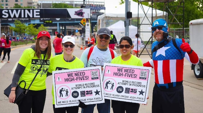 Jim Foliano, right, executive director of Ticket to Hope recently broke the World Record for the “Most Hi-Fives in 24 Hours” with 15,338 high-fives, making Cincinnati the soon-to-be High-Five Capital of the World. CONTRIBUTED