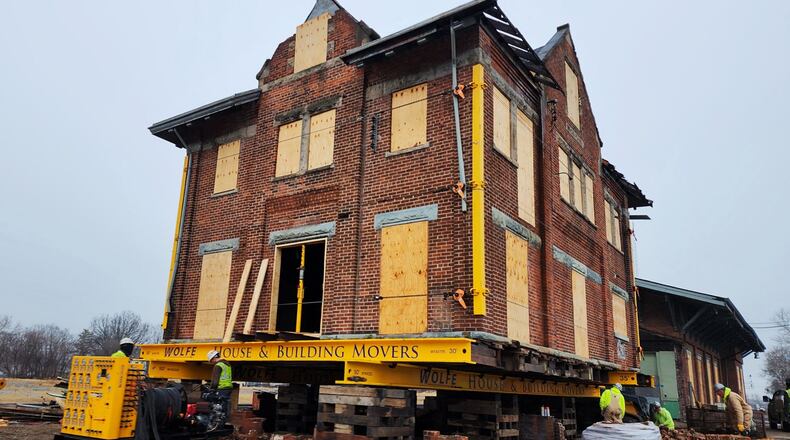 Crews with Wolfe House & Building Movers are getting the CSX train depot ready to be moved on Tuesday, Dec. 20, 2022. It will take multiple hours to move the 1,000-plus feet north on Martin Luther King Jr. Boulevard to its new location at the corner of Maple Avenue and MLK Boulevard. NICK GRAHAM/STAFF