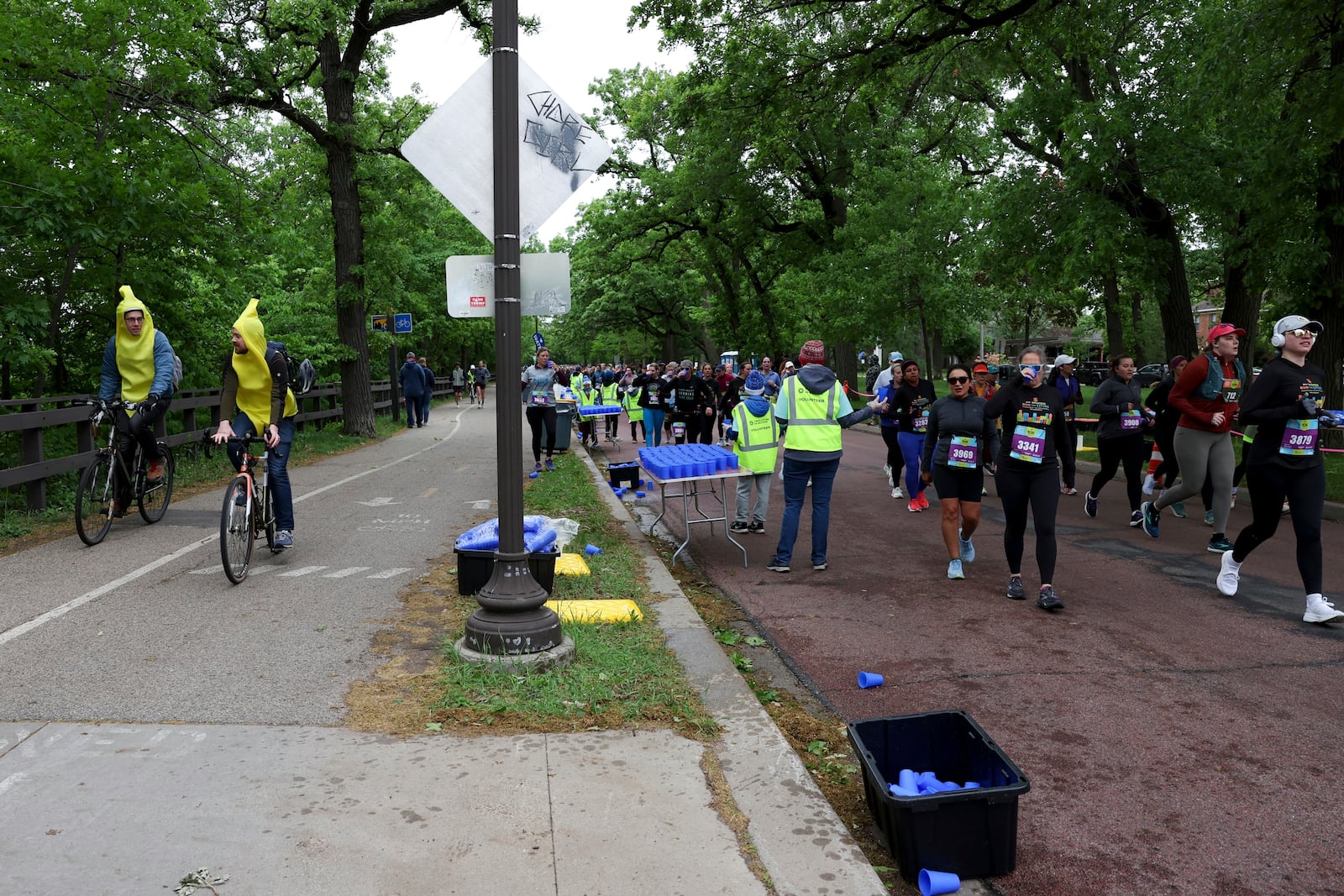 Runners get hydration via Hiccup, a reusable silicone cup, during the PNC Women Run the Cities race on Saturday, May 17, 2025, in Minneapolis. (AP Photo/Ellen Schmidt)