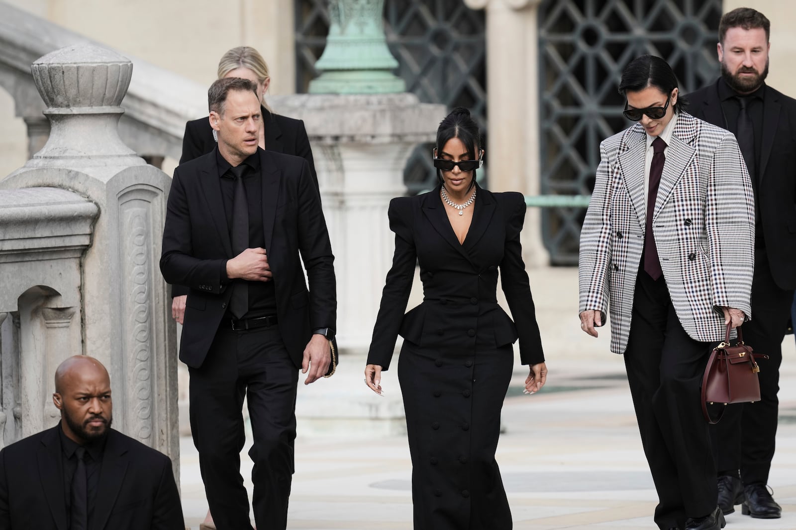 Kim Kardashian, center, accompanied by her mother Kris Jenner, second right, leaves the justice palace after testifying, regarding a robbery of millions of dollars in jewels from her Paris hotel room in 2016, in Paris, Tuesday, May 13, 2025. (AP Photo/Aurelien Morissard)