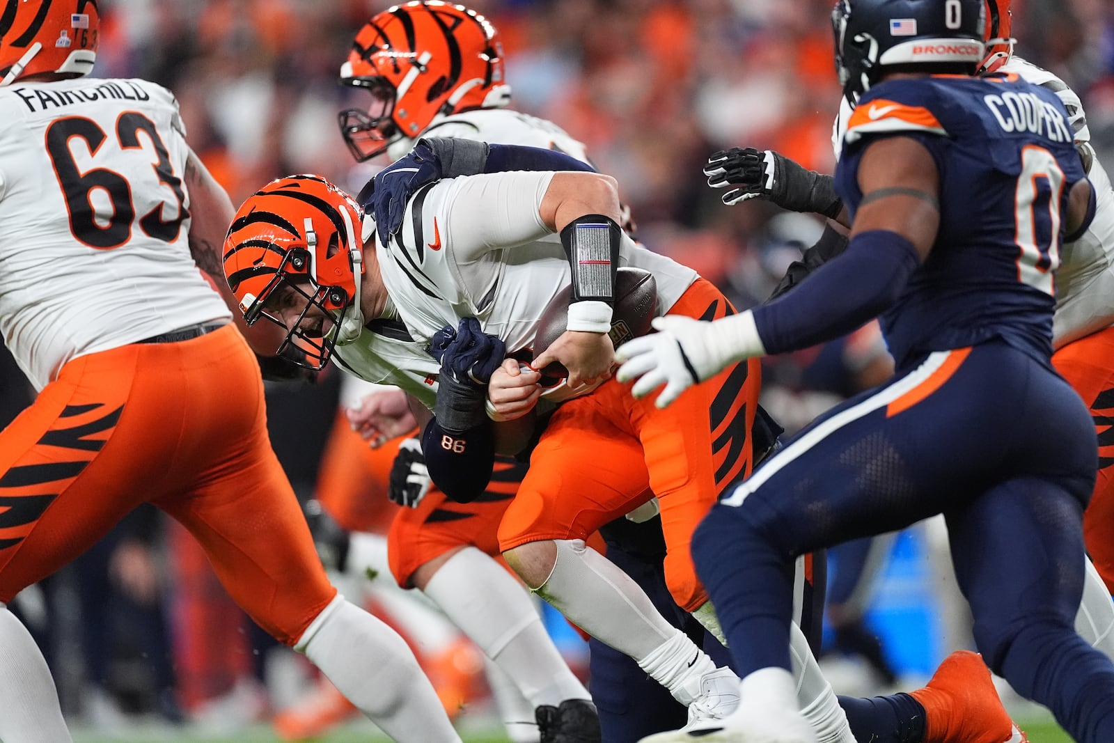 Denver Broncos defensive end John Franklin-Myers (98) sacks Cincinnati Bengals quarterback Jake Browning (6) during the second half of an NFL football game Monday, Sept. 29, 2025, in Denver. (AP Photo/David Zalubowski)