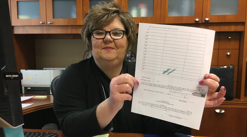 Butler County Board of Elections Director Diane Noonan with a city of Hamilton elections petition, which can be confusing. City officials are considering changes to Hamilton’s charter to make updates and improvements, including to the petitions and election deadlines for those running for city council. MIKE RUTLEDGE/STAFF