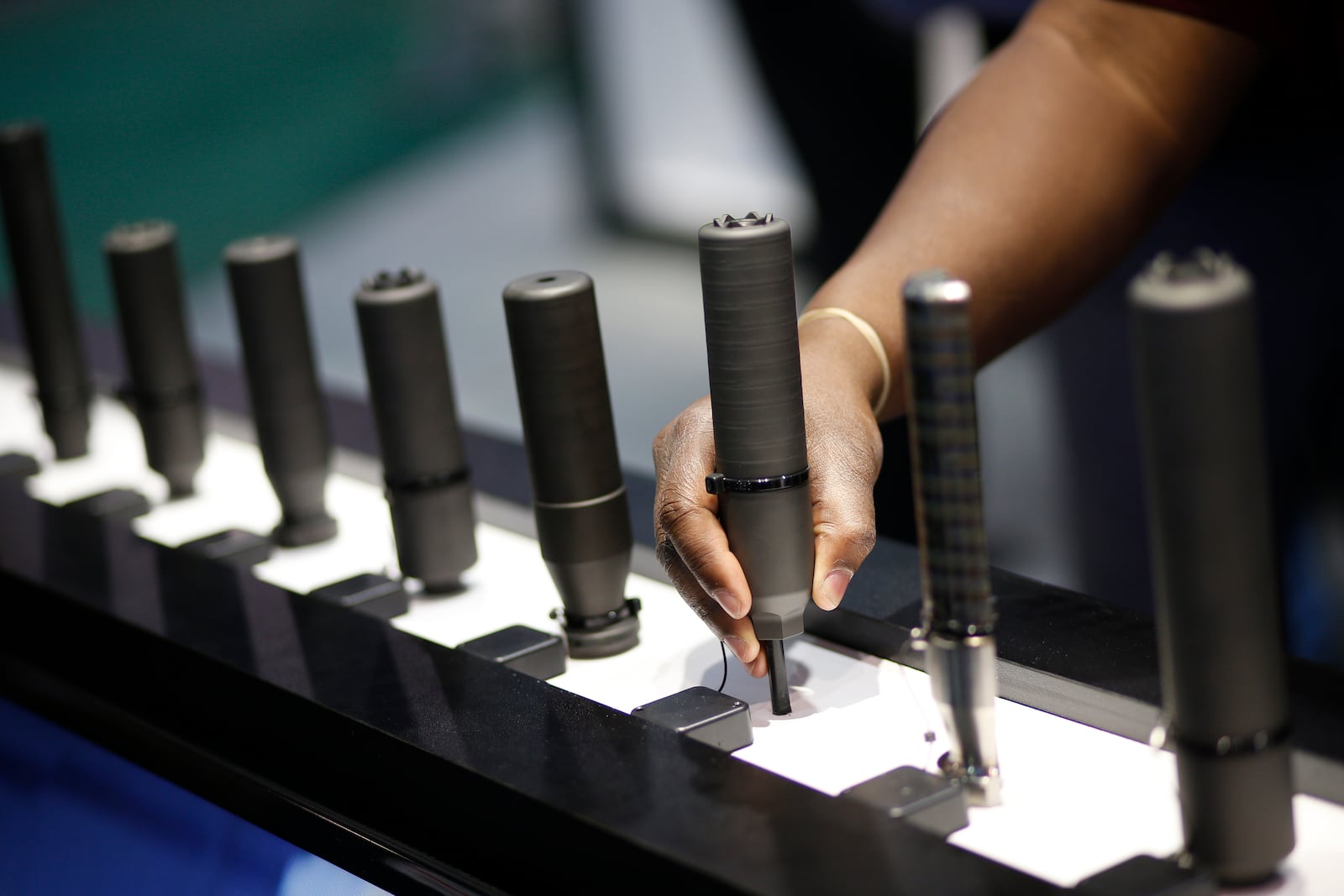 FILE- Gun silencers are on display at the Sig Sauer booth at the Shooting, Hunting and Outdoor Trade Show in Las Vegas, Jan. 19, 2016. (AP Photo/John Locher, File)