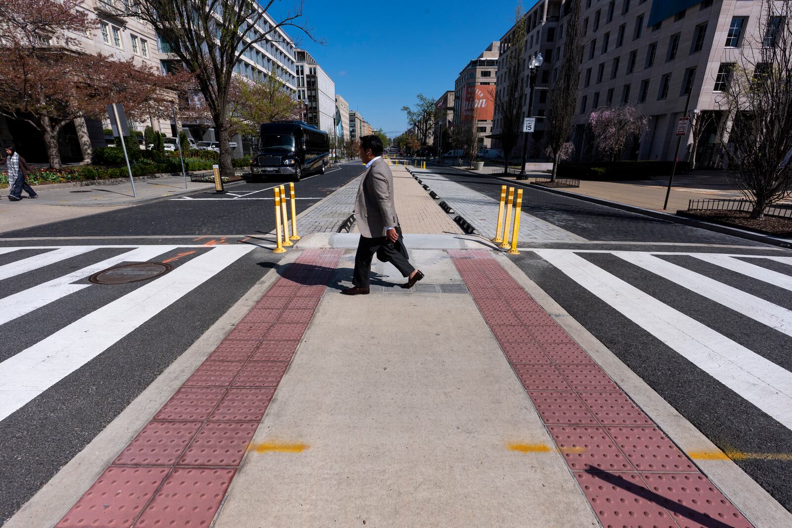 A man walks across 16th Street NW, after Black Lives Matter Plaza has been re-done eliminating the tribute, Tuesday, April 1, 2025, in Washington. (AP Photo/Alex Brandon)