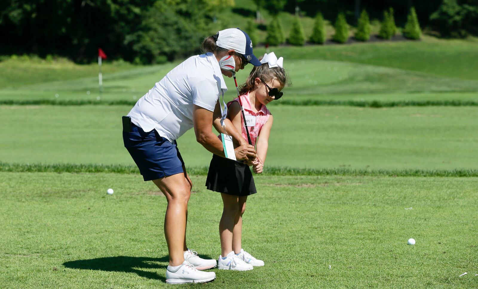 McKinley Hurley, 6, of Springboro, participates in the Annika Foundation Share My Passion Clinic at NCR Country club on Tuesday, Aug. 23, 2022, two days before the start of the U.S. Women's Senior Open in Kettering. Jana Dalton, the head pro at Community Golf Club in Dayton, works with Hurley on her swing. David Jablonski/Staff