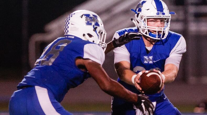 Hamilton quarterback Elijah Spradling hands the ball off to Keyshawn Stephens during their game against Middletown on Oct. 5 at Virgil Schwarm Stadium in Hamilton. Host Big Blue won 15-14. NICK GRAHAM/STAFF