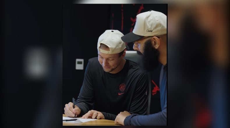 Luke Kennard signs his one-year contract Tuesday, July 8, with the Atlanta Hawks. This will be Kennard's fourth team he has played on. Photo courtesy of Atlanta Hawks