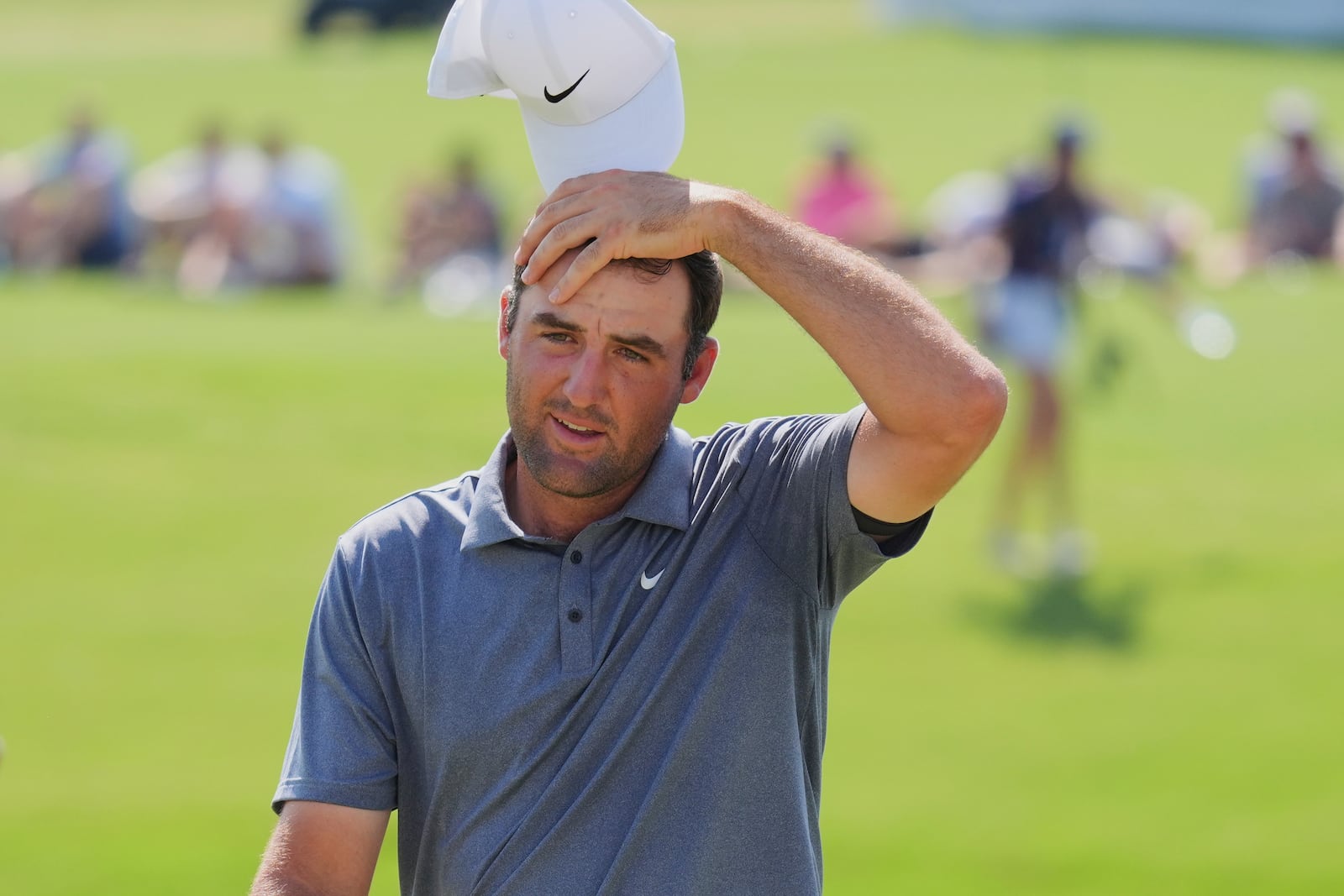 Scottie Scheffler reacts after finishing on the 18th hole during the final round of the Charles Schwab Challenge golf tournament at Colonial Country Club in Fort Worth, Texas, Sunday, May 25, 2025. (AP Photo/LM Otero)