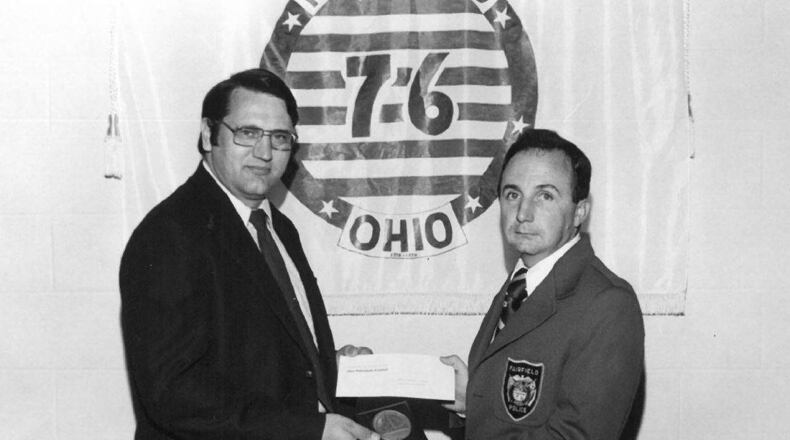 Former Fairfield Police Officer Ray Hounchell receives the 1976 Outstanding Ohio Police Officer in the Field of Highway Safety from then Fairfield Police Chief Tom Marsh. Hounchell served 28 years as a police officer for the city of Fairfield before retiring in August 1997. PROVIDED/CITY OF FAIRFIELD
