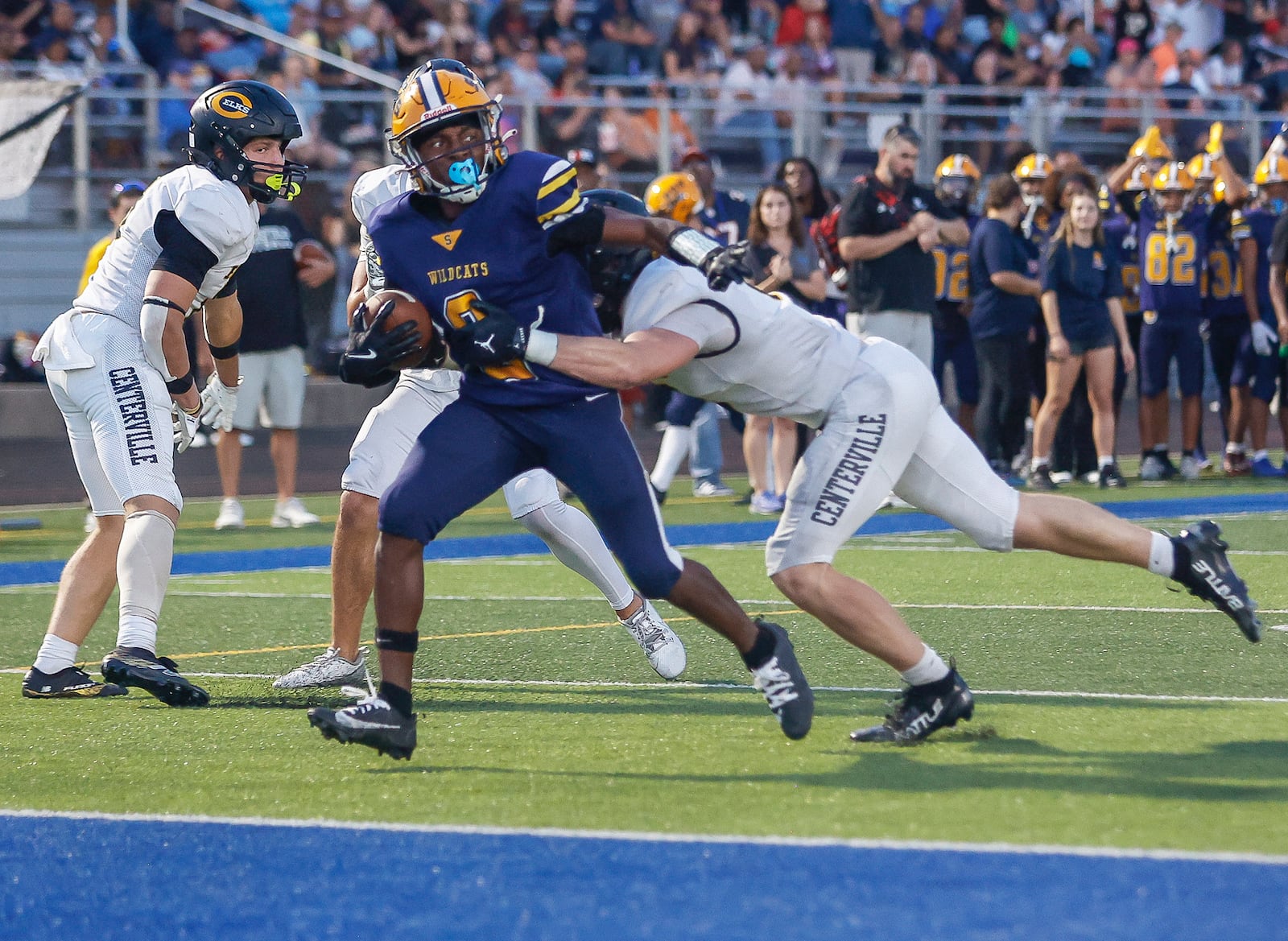 Springfield's Sherrod Lay Jr. (#2) runs toward the end zone as Centerville's AJ Taylor (#6) tries to tackle him during a game on Friday, September 19, 2025, at Springfield High School. JOSEPH COOKE/STAFF