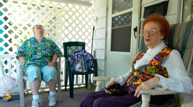 Opal Hatton, 94, jokes with Elizabeth Barnes from Personal Touch Home Care during a in this 2007 file photo to Hatton’s home in Middletown. STAFF FILE PHOTO