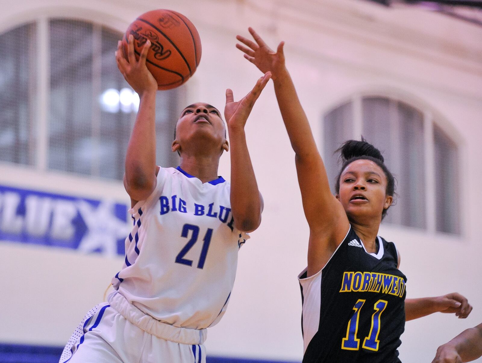 Hamilton’s CiCi Riggins puts up a shot defended by Northwest’s Anye’ Shabazz during Thursday night’s game at the Hamilton Freshman School. Riggins became Big Blue’s all-time leading scorer in girls basketball, but the visiting Knights won 62-51. NICK GRAHAM/STAFF