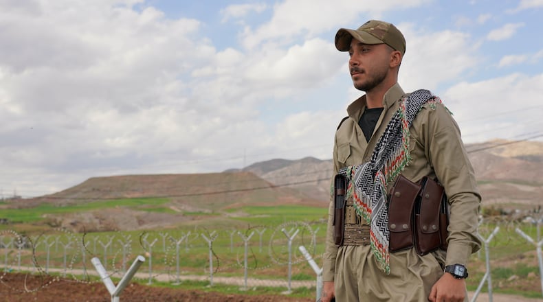 Member of the Democratic Party of Iranian Kurdistan PDKI stands at a checkpoint leading to their base in Koya district of Irbil, Iraq, Friday, Feb. 27, 2026. (AP Photo/Rashid Yahya)