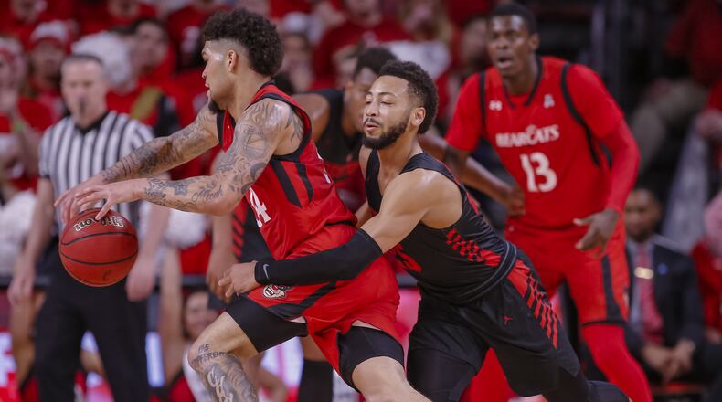 CINCINNATI, OH - MARCH 10: Jarron Cumberland #34 of the Cincinnati Bearcats dribbles the ball in the back court as Galen Robinson Jr. #25 of the Houston Cougars defends from behind at Fifth Third Arena on March 10, 2019 in Cincinnati, Ohio. The Bearcats beat the Cougars in Sunday’s AAC championship game in Memphis. (Photo by Michael Hickey/Getty Images)