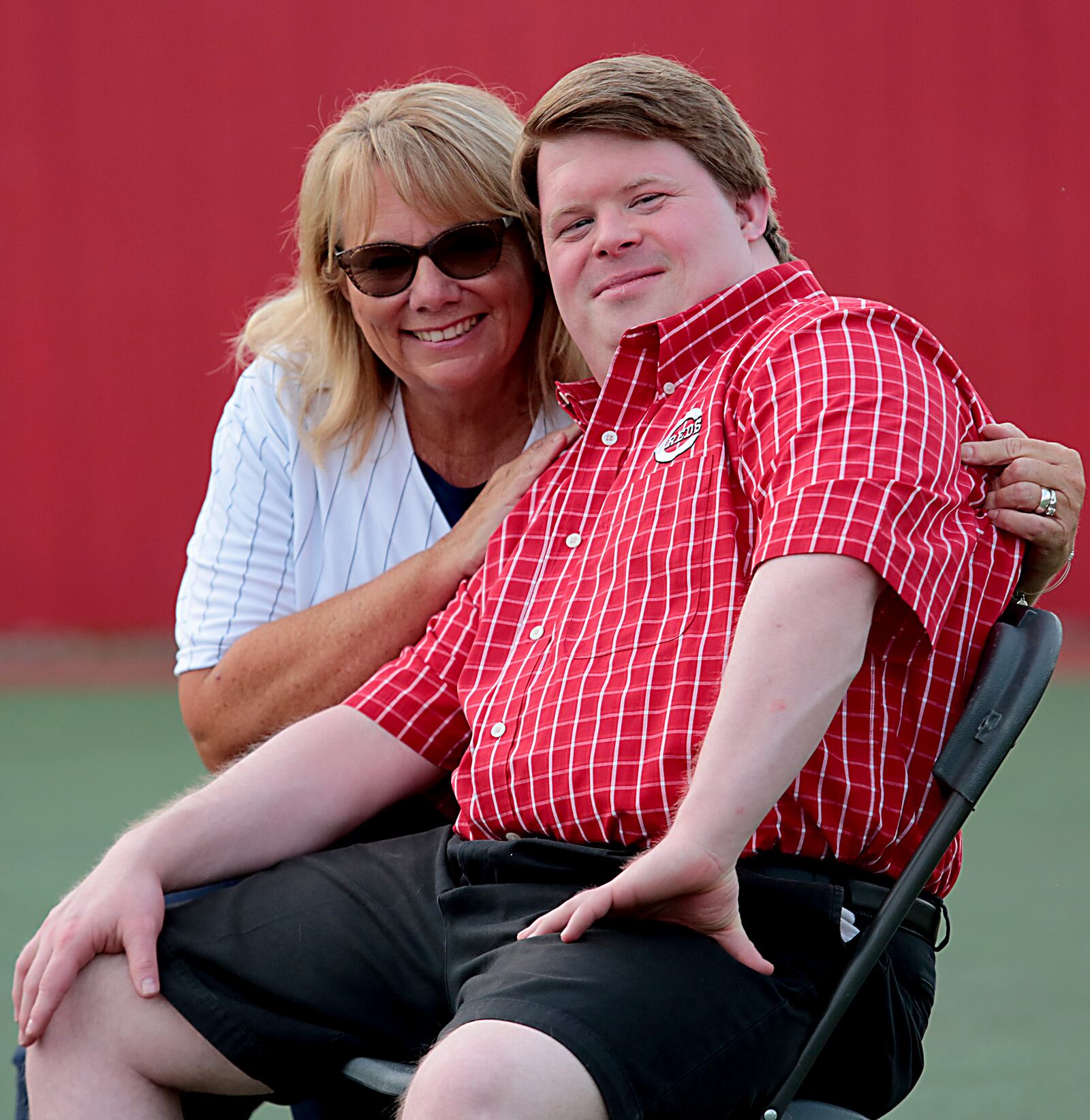 Connie Mehlman, community outreach coordinator for the Butler County Board of Developmental Disabilities, poses with Teddy Kremer, a young man with Down syndrome who once served as Cincinnati Reds bat boy. SUBMITTED PHOTO