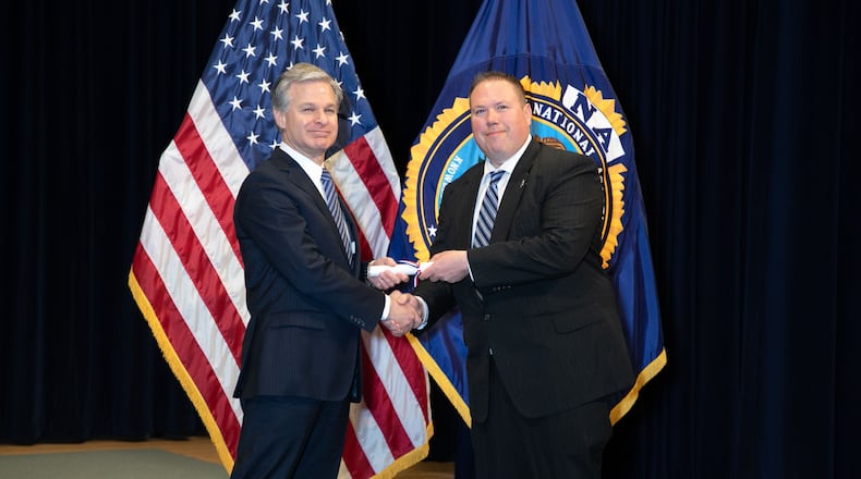 Oxford Police Chief John Jones accepting his certificate from FBI Director Christopher Wray after graduating from the agency's 10-week National Academy on March 16, 2023. PROVIDED