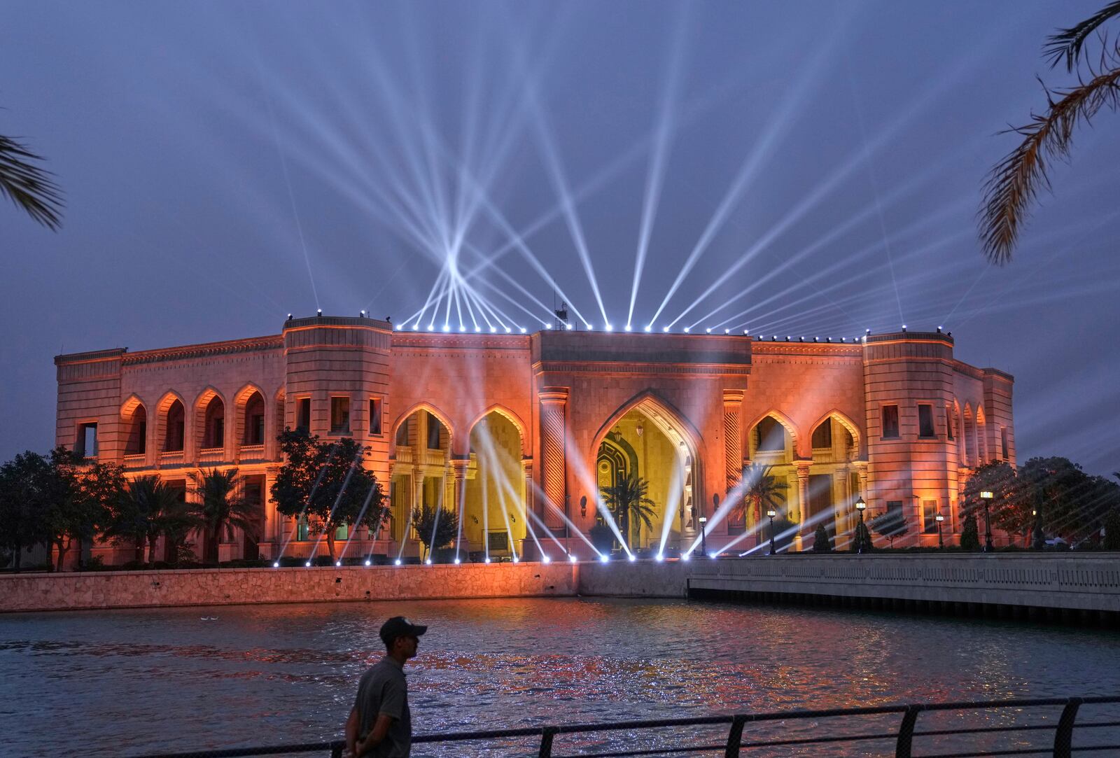 Lights are projected from former Iraqi leader Saddam Hussein's al-Faw Palace in Baghdad, Iraq, Saturday, May 24, 2025, now the location of The American University of Iraq - Baghdad. (AP Photo/Hadi Mizban)