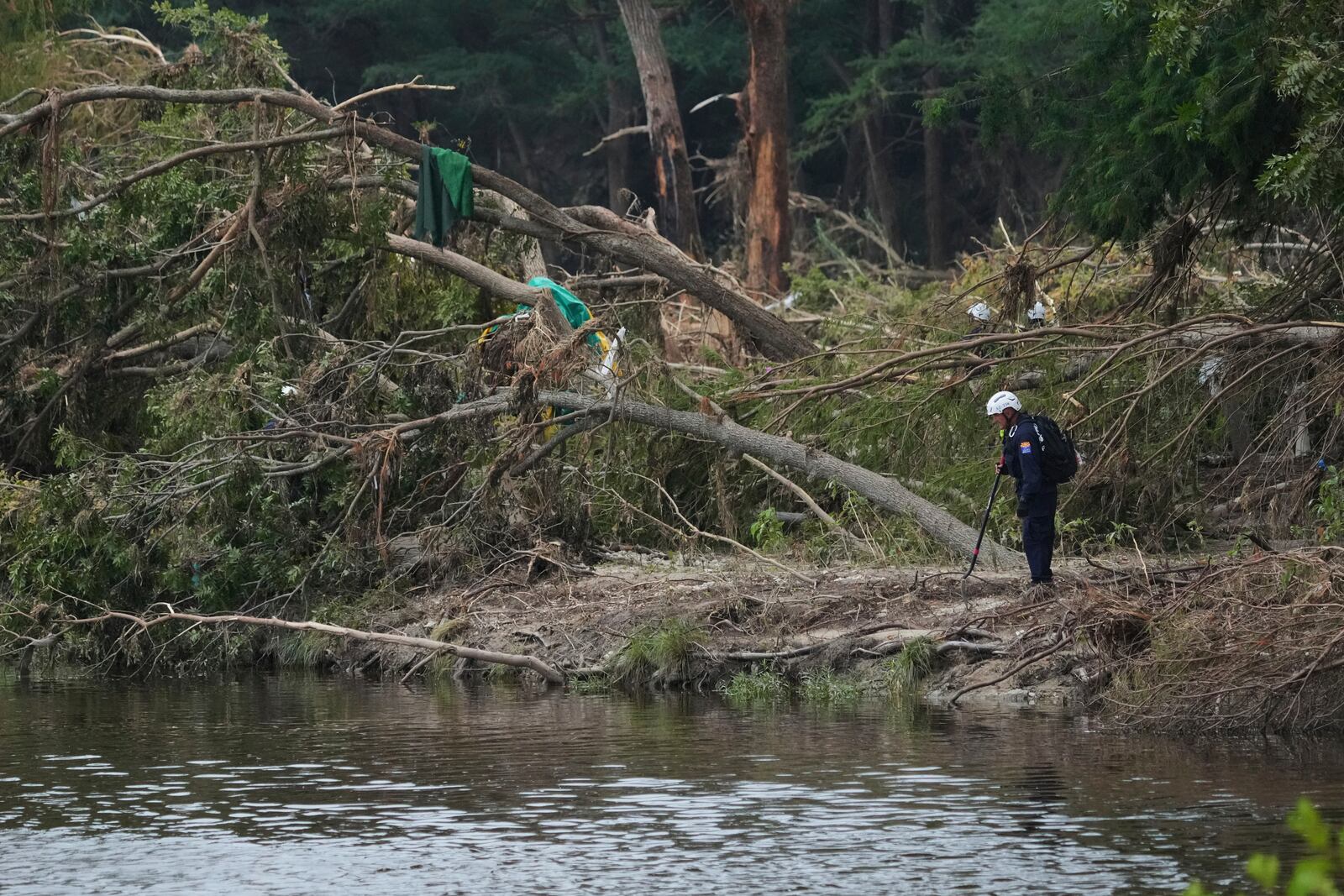 Search and rescue teams comb the banks of the Guadalupe River after a flash flood swept through the area, Saturday, July 12, 2025, in Kerrville, Texas. (AP Photo/Eric Gay)