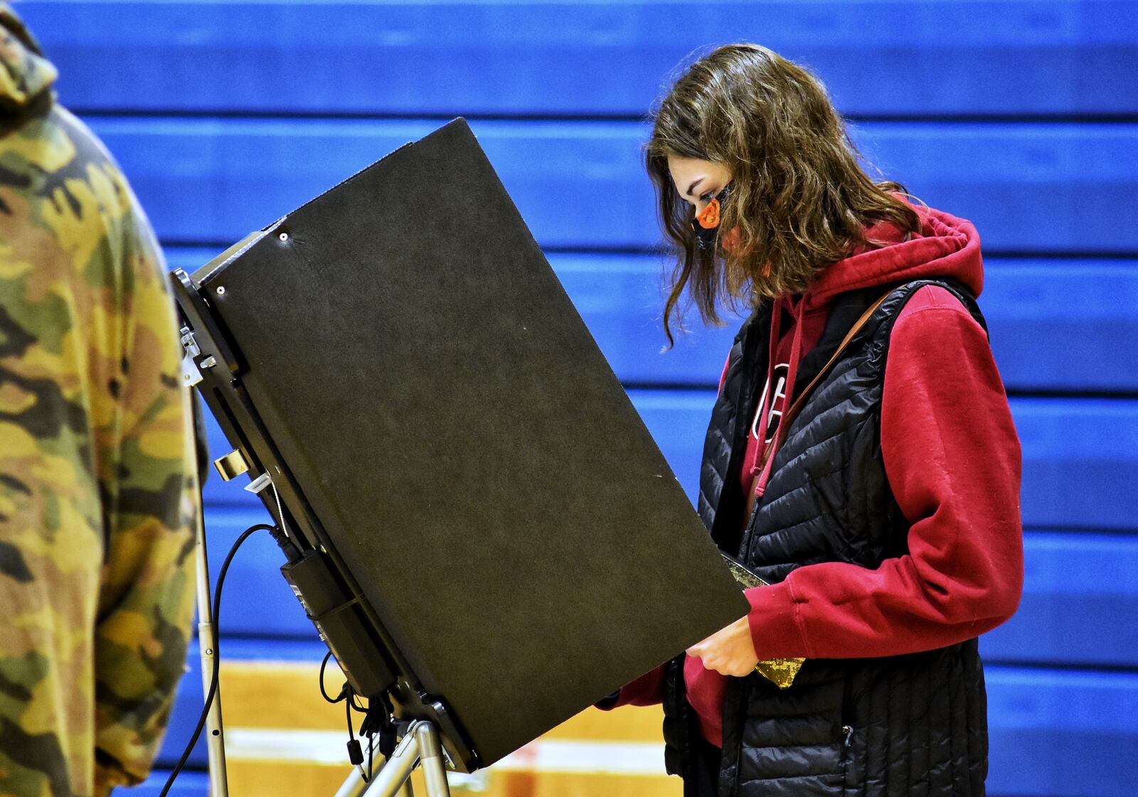 Alexys Napier, 18, votes for the first time on election day Tuesday, Nov. 3, 2020 at Wilson Middle School in Hamilton. NICK GRAHAM / STAFF