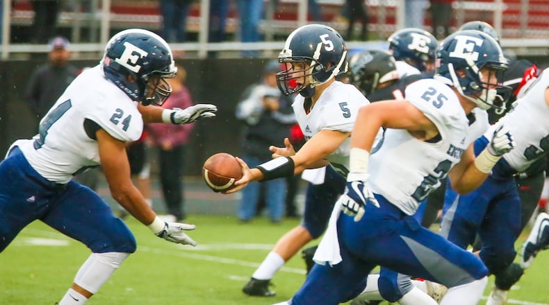Edgewood quarterback Corbin Craft (5) hands off to fullback Elijah Williams (24) during their game against Franklin on Sept. 1 at Atrium Stadium in Franklin. The host Wildcats won 49-21. GREG LYNCH/STAFF
