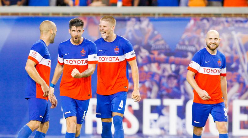 FC Cincinnati players celebrate their 1-0 victory over the Columbus Crew after their Open Cup match, held at Nippert Stadium on the campus of the University of Cincinnati, Wednesday, June 14, 2017. GREG LYNCH / STAFF