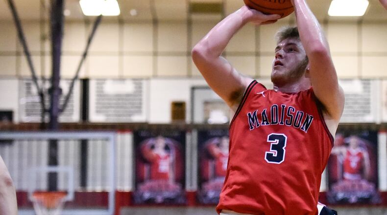 Madison’s Mason Whiteman puts up a shot during a basketball game at Carlisle on Jan. 18. Madison won 58-39. NICK GRAHAM/STAFF