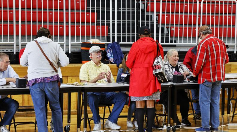 Butler County Board of Elections poll workers check in voters at Creekside Middle School Tuesday, May 3, 2022 in Fairfield. NICK GRAHAM/STAFF
