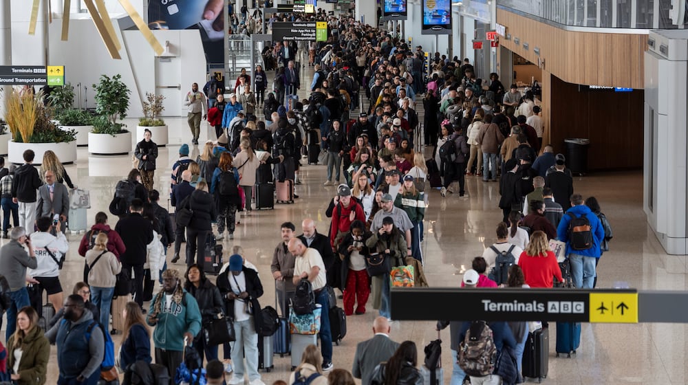 Travelers wait in a TSA line, Wednesday, March 25, 2026, at LaGuardia Airport in New York. (AP Photo/Yuki Iwamura)