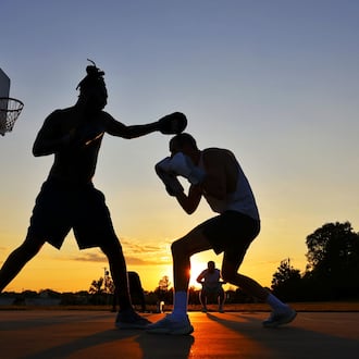 Jakaleb Silas, left, and Bryce Adkins practice boxing along with other friends on the basketball court at Jacot Park Thursday, Sept. 11, 2025 in Middletown. NICK GRAHAM/STAFF