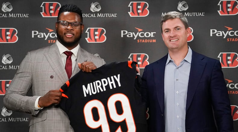 Clemson defensive end Miles Murphy, left, the Cincinnati Bengals' first-round draft pick, poses for a portrait with Cincinnati Bengals head coach Zac Taylor, right, during a news conference, Saturday, April 29, 2023, in Cincinnati. (AP Photo/Joshua A. Bickel)