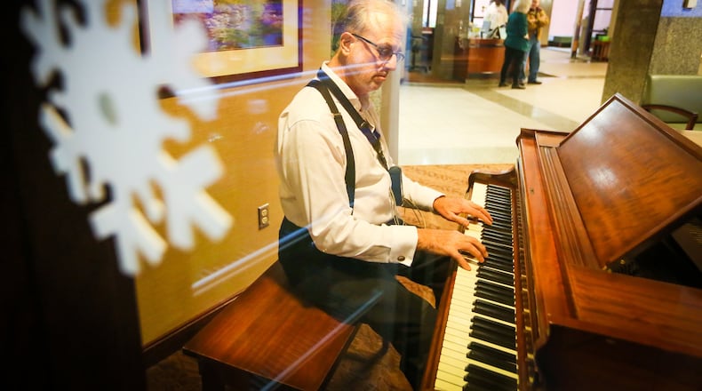 Hamilton Fairfield Symphony Orchestra Conductor Paul Stanbery, shown performing at Fort Hamilton Hospital in December, says the orchestra is being renamed the Butler Philharmonic. GREG LYNCH / STAFF