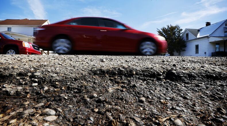 The city of Hamilton plans to address pothole issues on several small neighborhood streets this summer and fall by milling and filling the bad sections of asphalt. This section of Cleveland Ave. is one of the several streets that will be first targeted by the city's Public Works Department. NICK GRAHAM/STAFF