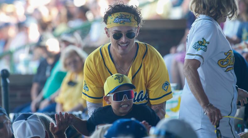 Northwestern High School grad Gage Voorhees participates in a race through the grandstands with a young fan on Saturday, June 25, 2022, at Grayson Stadium in Savannah, Ga. Photo by Michael Cooper