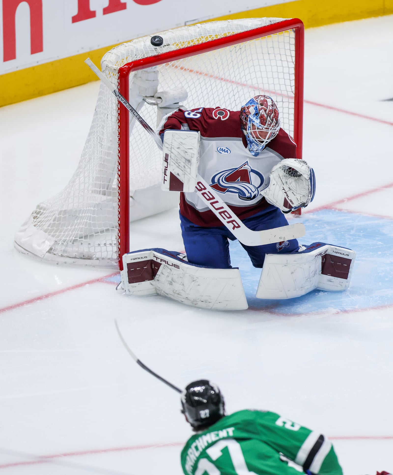 Dallas Stars left wing Mason Marchment, bottom, misses a shot against Colorado Avalanche goaltender Mackenzie Blackwood, top, during a first-round NHL hockey playoff game in Dallas, Saturday, April 19, 2025. (AP Photo/Gareth Patterson)
